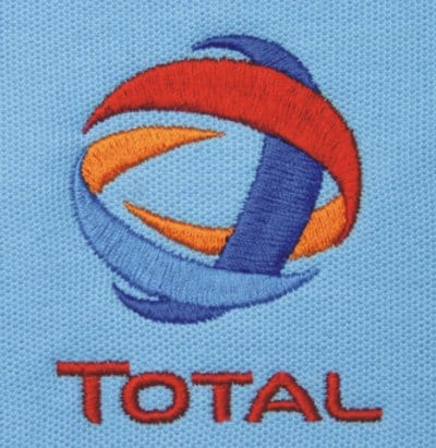 A close up view of a stiched logo on a cotton top